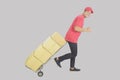 Delivery man or courier pushing hand truck with stack of boxes and showing like Royalty Free Stock Photo