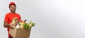 Delivery Concept - Handsome African American delivery man carrying package box of grocery food and drink from store Royalty Free Stock Photo