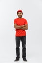 Delivery Concept - Handsome African American delivery man crossed arms over isolated on Grey studio Background. Copy