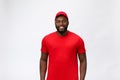 Delivery Concept - Handsome African American delivery man. Isolated on Grey studio Background. Copy Space Royalty Free Stock Photo