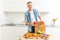 Delivery Concept - Handsome Cacasian delivery man carrying package box of grocery food and drink from store. Copy Space. Royalty Free Stock Photo