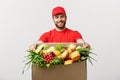 Delivery Concept - Handsome Cacasian delivery man carrying package box of grocery food and drink from store. Isolated on Royalty Free Stock Photo