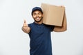 Delivery Concept - Portrait of Happy African American delivery man holding a box package and showing thumps up. Isolated Royalty Free Stock Photo