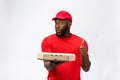 Delivery Concept - Portrait of Happy African American delivery man holding a pizza box package and showing thumbs up Royalty Free Stock Photo