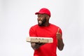 Delivery Concept - Portrait of Happy African American delivery man holding a pizza box package and showing thumbs up Royalty Free Stock Photo