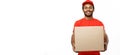 Delivery Concept - Portrait of Happy African American delivery man in red cloth holding a box package. Isolated on white Royalty Free Stock Photo