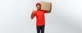 Delivery Concept - Portrait of Happy African American delivery man holding a box package and showing thumps up. Isolated Royalty Free Stock Photo