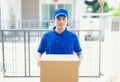 Delivery concept - Portrait delivery person in blue uniform hold