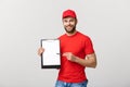 Delivery Concept: Portrait Young caucasian Handsome delivery man or courier showing a confirmation document form to sign Royalty Free Stock Photo