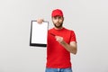 Delivery Concept: Portrait Young caucasian Handsome delivery man or courier showing a confirmation document form to sign Royalty Free Stock Photo
