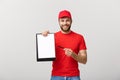 Delivery Concept: Portrait Young caucasian Handsome delivery man or courier showing a confirmation document form to sign Royalty Free Stock Photo