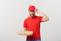 Delivery Concept: Young haapy caucasian Handsome Pizza delivery man holding pizza boxes isolated over grey background Royalty Free Stock Photo