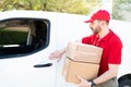 Delivery courier picking up packages to deliver in a truck