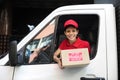 Delivery courier in truck handing over package Royalty Free Stock Photo