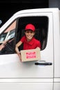 Delivery courier in truck with package Royalty Free Stock Photo