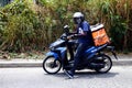 Delivery on demand motorcycle courier with a package out for delivery