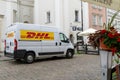 Delivery by DHL. White minibus on the street, delivery of settlements and documents. Poland, Warsaw - July 26, 2023