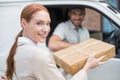 Delivery driver handing parcel to customer in his van Royalty Free Stock Photo