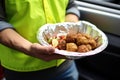 delivery driver holding a falafel bowl package for a customer