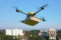 Delivery drone with pizza box flying over the town