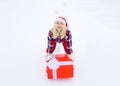 Delivery girl with winter gift box. Winter fun activities. Winter emotion. Crazy Christmas girl pushes a big gift on