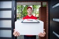 Delivery guy handing in parcel Royalty Free Stock Photo
