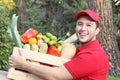 Delivery guy holding box with groceries Royalty Free Stock Photo