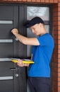 Delivery guy knocking on door Royalty Free Stock Photo