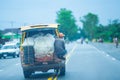 Delivery khmer man holding old minivan transport on the road to Royalty Free Stock Photo