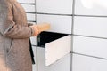 Delivery locker. Post automat terminal and hands with parcel courier box. Online purchase delivery service concept.