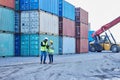 Delivery, logistics and leader coaching at a container supply chain warehouse outdoors for stock inspection. Forklift Royalty Free Stock Photo