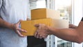 Delivery mail man giving parcel box to recipient, Young owner accepting of cardboard boxes package from post shipment, Home Royalty Free Stock Photo