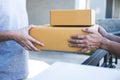 Delivery mail man giving parcel box to recipient, Young owner accepting of cardboard boxes package from post shipment, Home Royalty Free Stock Photo