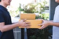 Delivery mail man giving parcel box to recipient, Young owner accepting of cardboard boxes package from post shipment, Home Royalty Free Stock Photo