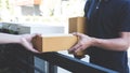 Delivery mail man giving parcel box to recipient, Young owner accepting of cardboard boxes package from post shipment, Home Royalty Free Stock Photo