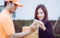 Delivery man asking woman to sign mobile for the delivery