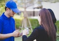 Delivery man asking woman to sign mobile for the delivery