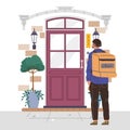 Delivery man with big box standing at front door. Courier shipping goods or food to costumers Royalty Free Stock Photo