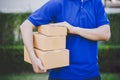 Delivery man in blue handing packages Royalty Free Stock Photo