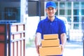 Delivery man in Blue handing packages to home Royalty Free Stock Photo
