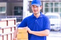 Delivery man in Blue handing packages to home Royalty Free Stock Photo