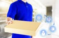 Delivery man in blue uniform and hands holding paper box for delivering package on icon media background. Concept order online Royalty Free Stock Photo