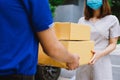 the delivery man in blue uniform sending a delivery of boxes to recipient