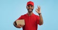 Delivery man, box and okay hands for success, product excellence and courier services in studio. Happy face of supply Royalty Free Stock Photo