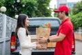 A delivery man bringing fresh food packages to a customer on a business day