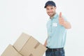 Delivery man with cardboard boxes gesturing thumbs up Royalty Free Stock Photo