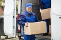 Delivery Man Carrying Cardboard Box Royalty Free Stock Photo