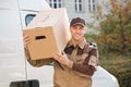 Delivery Man Carrying Cardboard Box On Shoulder Royalty Free Stock Photo