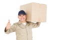 Delivery man carrying a package and showing a thumbs up Royalty Free Stock Photo