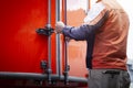 Delivery Man Closing The Door of A Container Van. Cargo Container Door Locked Protect Safety. Shipping Freight Trucks Logistics